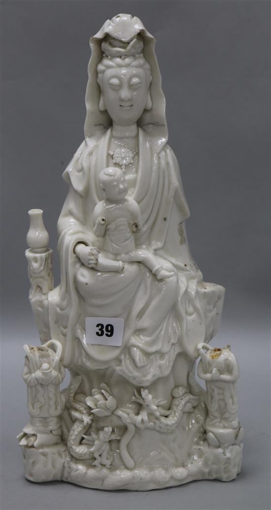 A large Chinese blanc de chine group of Guanyin and child, Kangxi period, damage and losses